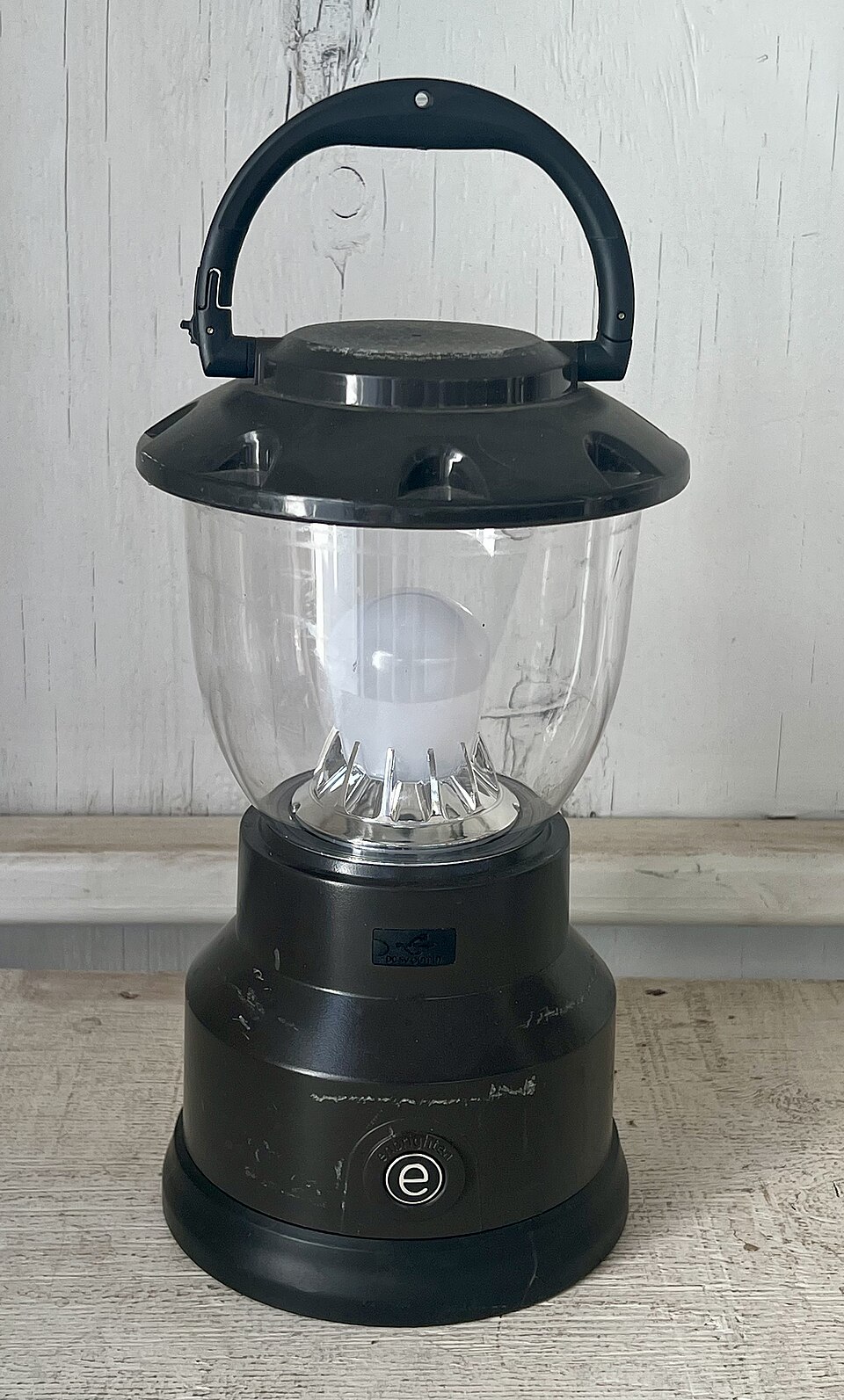 A black LED camping lantern with a clear globe and a top carry handle, for storm prep in Panama City, FL